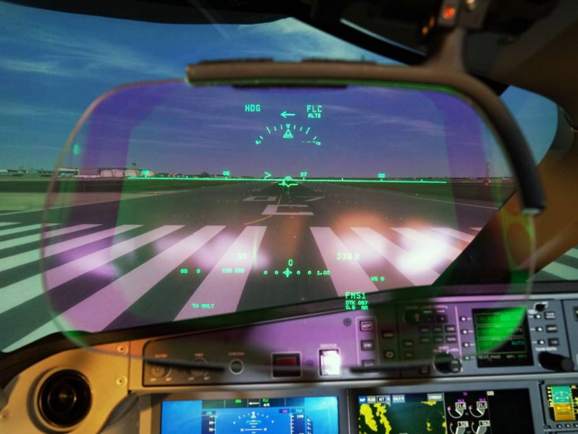 A220 cockpit view Head-up display of the Airbus A220 in front of cockpit instruments and the projected runway.